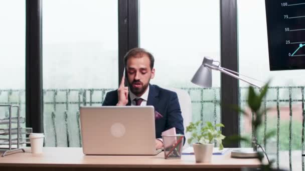 In modern office with big windows corporate worker talks on the phone. - Materiaali, video