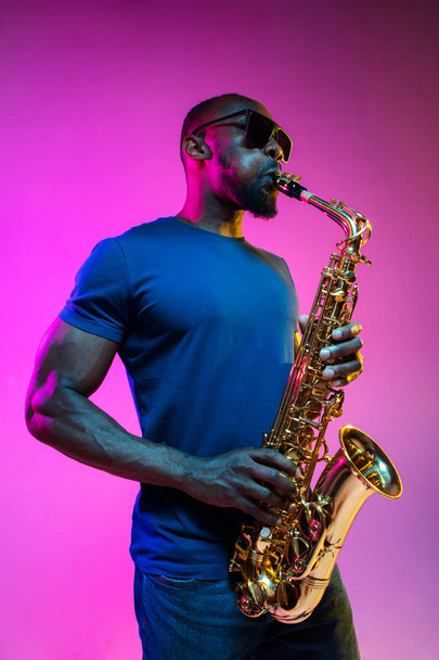 Young african-american jazz musician playing the saxophone - Fotografie, Obrázek