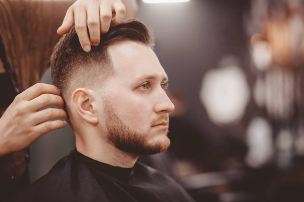 Barbershop banner. Man in barber chair, hairdresser styling his hair. - Фото, зображення