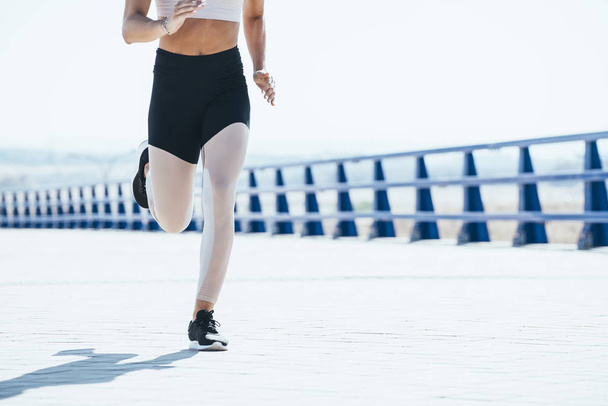 Outdoor shot of a fit young woman running. - Photo, Image