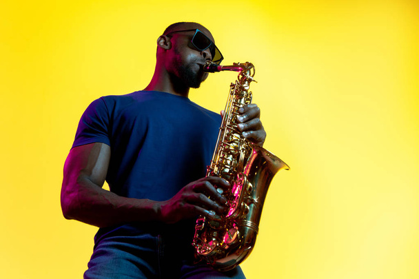 Young african-american jazz musician playing the saxophone - Φωτογραφία, εικόνα