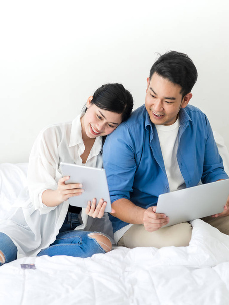 Happy Asian couple using laptop at home, lifestyle concept. - Fotoğraf, Görsel