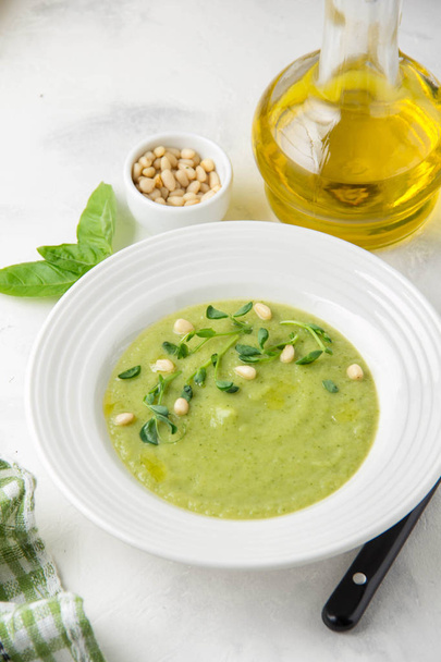 Vegetable green cream soup of peas, spinach, broccoli with pine  - Photo, image