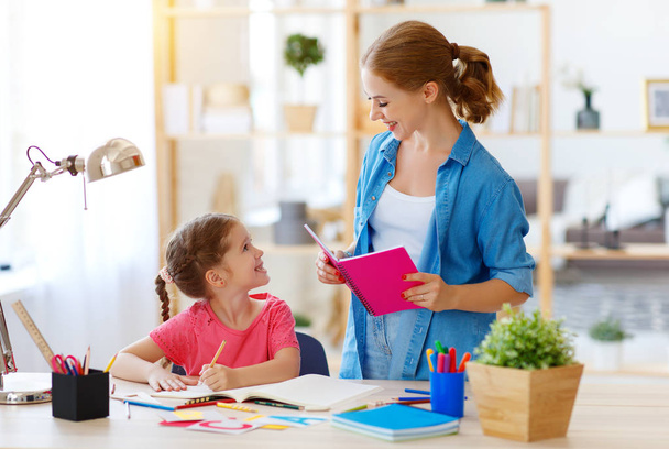 mother and child daughter doing homework geography with globe - Фото, зображення