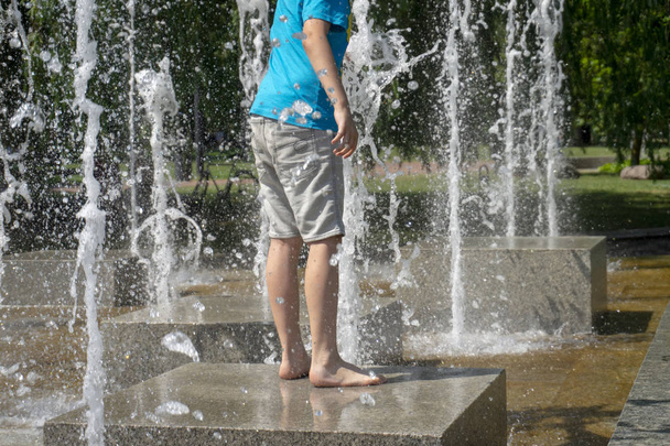 Barefoot person standing in a marble fountain - Photo, Image