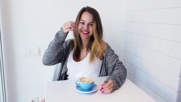 Beauty smiling girl at cafe during coffee break. Slow motion - Filmagem, Vídeo