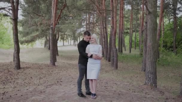 Beautiful and happy loving couple are tenderly embracing in the forest. - Footage, Video