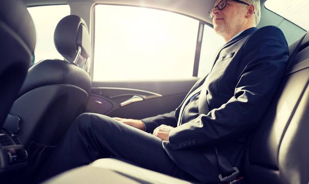 senior businessman driving on car back seat - Φωτογραφία, εικόνα