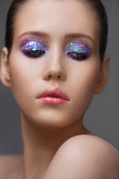 Art makeup many sequins and rhinestones of different shapes - Foto, Imagem