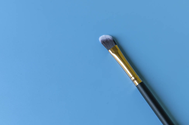 Makeup brush on a blue background - Photo, Image