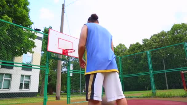 Sport motivation. Street basketball. The player scores the ball in the basket on the street court. Training game of basketball. Concept sport, motivation, goal achievement, healthy lifestyle. - Footage, Video
