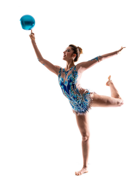 Girl doing rhythmic gymnastics with ball - Фото, зображення