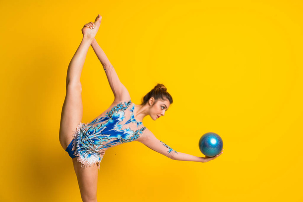 Girl doing rhythmic gymnastics with ball - Photo, image