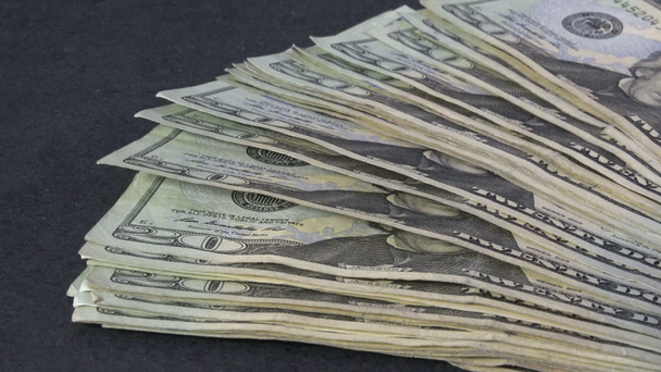 Fanning out a stack of twenty dollar bills, 4k - Footage, Video
