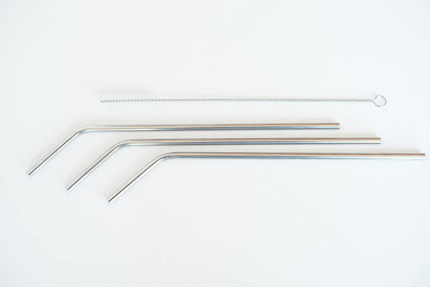 Lot of metal tubes for cocktails with schutkoy for cleaning isolated on white. - Фото, изображение