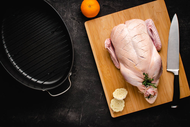 Whole Duck Fresh and Raw on Chopping Board with Ingredients Ready to Cook - 写真・画像