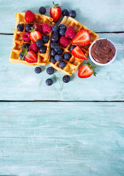sweet belgian waffles with berries and chocolate cream - 写真・画像