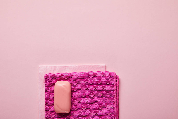 top view of pink rags and soap on pink background  - Fotografie, Obrázek