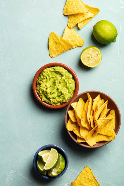 Nachos and fresh homemade guacamole on blue background - Valokuva, kuva
