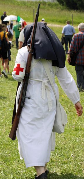 suora infermiera marciando durante una sessione di prove con una grande pistola su s
 - Foto, immagini