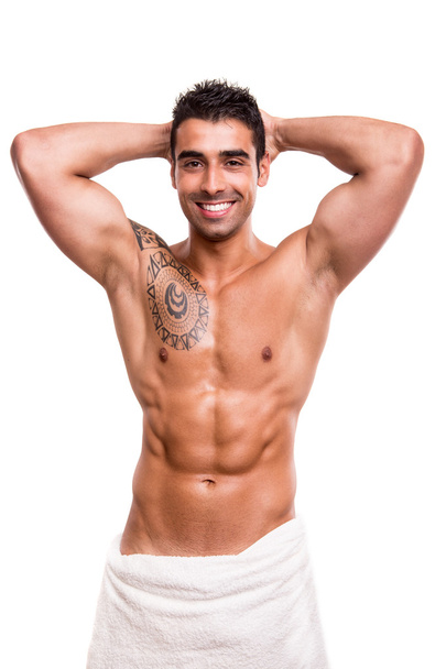 Attractive man posing with a white towel - Foto, imagen