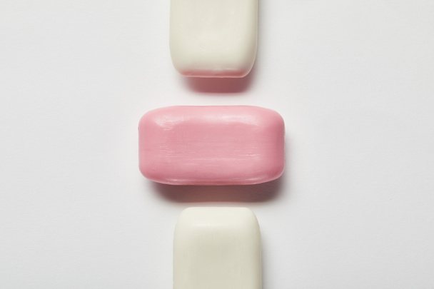 top view of pink and white soaps on grey background  - Foto, Imagen