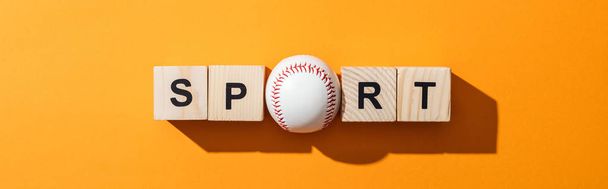 panoramic shot of softball near wooden cubes with sport lettering on yellow  - Photo, Image