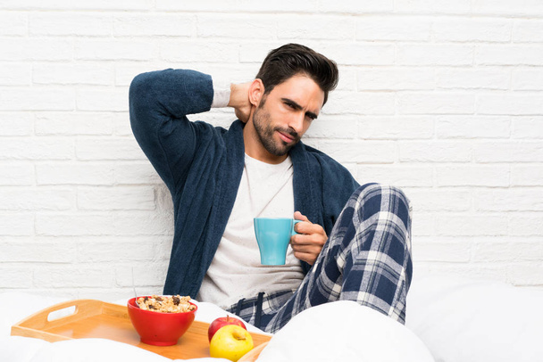 Man in bed with dressing gown and having breakfast - Photo, Image