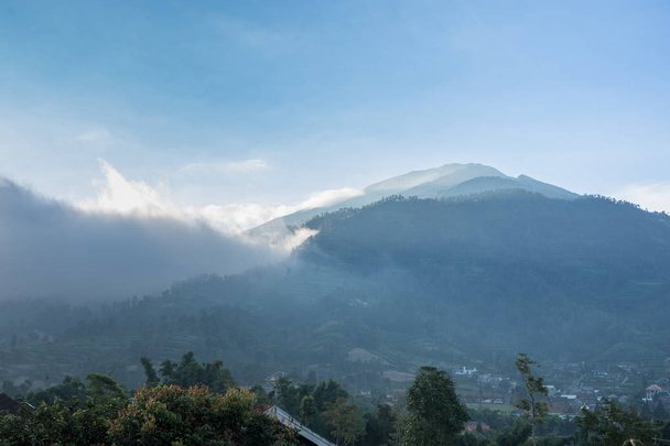 pico de la montaña que se levanta en las nubes en Asia
. - Foto, Imagen