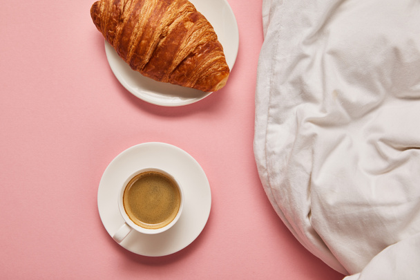 top view of blanket, coffee and croissant on pink background - Photo, Image