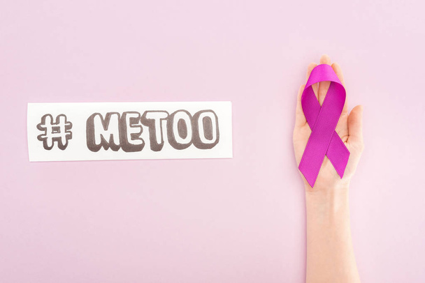 cropped view of purple awareness ribbon on hand of woman near paper with hashtag me too isolated on pink - Photo, Image