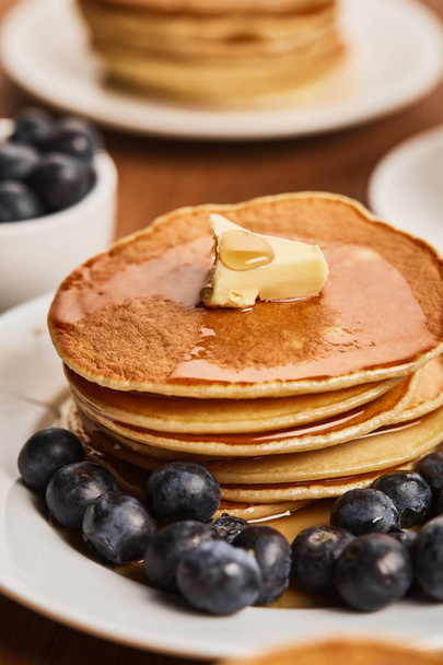 selective focus of pancakes with butter, syrup and blueberies - 写真・画像