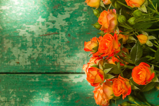 Orange roses on vintage wooden geen background. - Photo, Image
