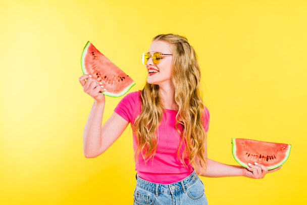 beautiful happy girl in sunglasses with watermelon On yellow - Fotó, kép