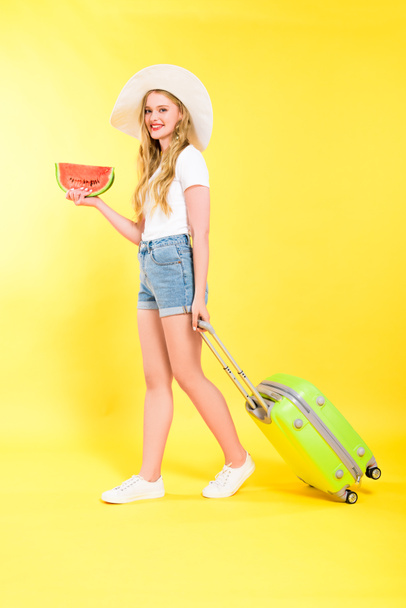 beautiful girl with suitcase and watermelon On yellow - Foto, Imagem