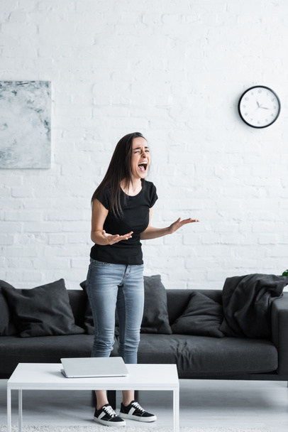 unhappy young woman screaming and gesturing while suffering from depression at home - Fotoğraf, Görsel
