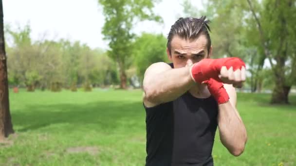 4. Modern man boxer training with  shadow. Blows in camera. City park outdoor sport team - Footage, Video