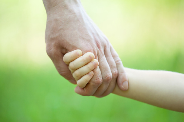 Child holding father's hand - Φωτογραφία, εικόνα