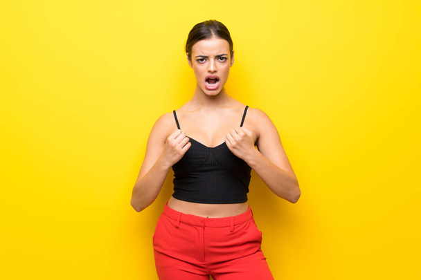 Young woman over isolated yellow background frustrated by a bad situation - Photo, Image