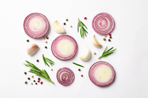 Flat lay composition with red onion rings and spices on white ba - Photo, Image