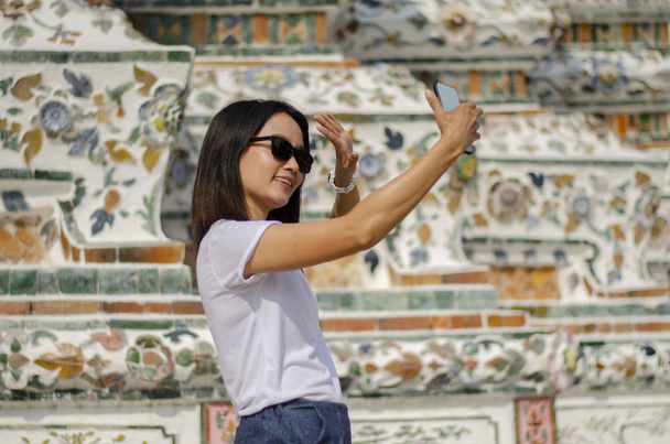 An Asian girl selfie with the Thai art wall - Фото, изображение