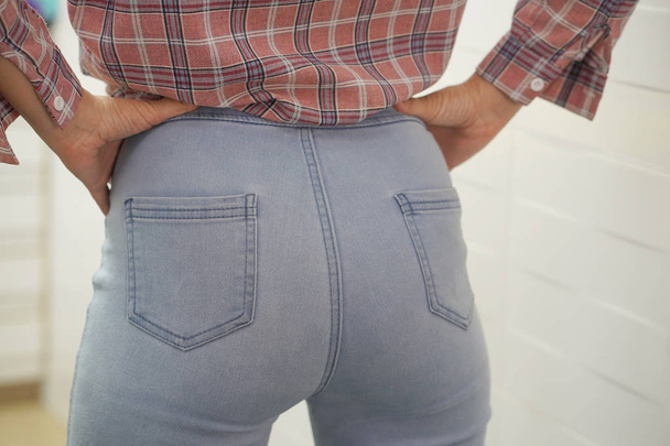 Sexy ass girl in jeans. Female bottom in tight jeans. - Photo, image