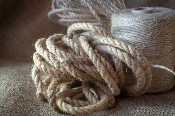 Jute rope and spools of burlap threads or twine - Foto, Imagen