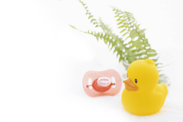 close-up view of funny yellow rubber duck and baby comforter - 写真・画像