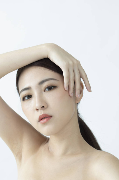 beautiful Asian woman touching her face - Фото, изображение