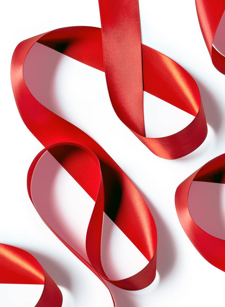Red silk or satin ribbon abstraction isolated on white backgroun - Photo, Image