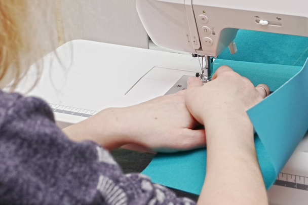 Seamstress at work on a sewing machine. - Foto, Imagem