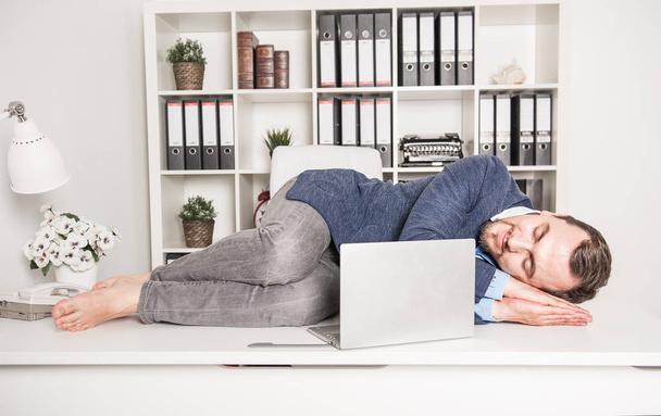 Business man sleeping on the table in office - Photo, image