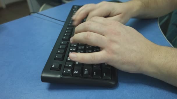 male hands typing on a black computer keyboard close-up - Materiał filmowy, wideo