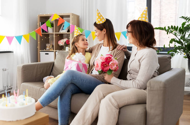 daughter with gift box greeting mother on birthday - Photo, image